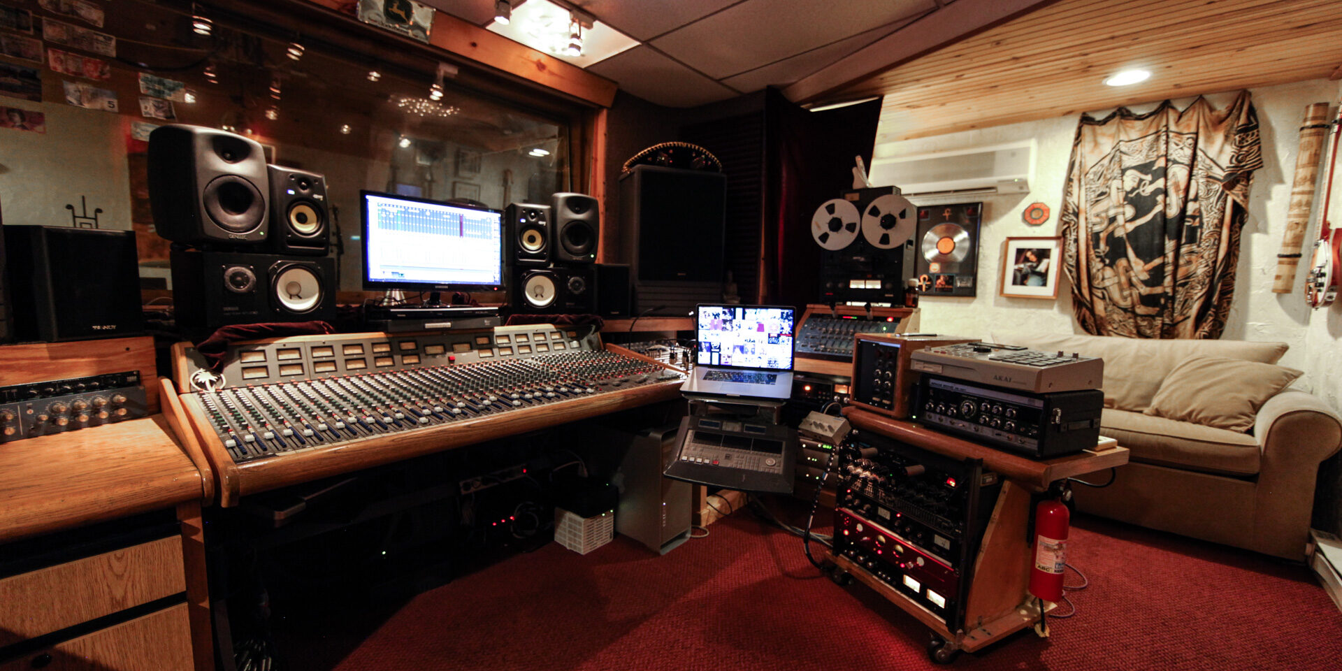 Interior photo of recording studio behind mixing console